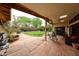 Inviting covered patio that overlooks a beautiful backyard with lush greenery and a charming water fountain at 5120 E Janice Way, Scottsdale, AZ 85254