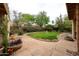 Serene backyard oasis with lush landscaping, a charming water fountain, and stone paving, creating a peaceful retreat at 5120 E Janice Way, Scottsdale, AZ 85254