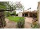 Expansive backyard features a covered patio and a well-maintained lawn with a decorative fountain, perfect for outdoor enjoyment at 5120 E Janice Way, Scottsdale, AZ 85254