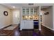 Elegant bar area with a wine cooler, granite countertop, and stylish cabinetry, ideal for entertaining guests at 5120 E Janice Way, Scottsdale, AZ 85254
