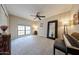 Neutral bedroom features large windows, ceiling fan, piano, and statement mirror at 5120 E Janice Way, Scottsdale, AZ 85254