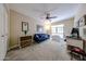 Well lit bedroom with blue sofa and a ceiling fan at 5120 E Janice Way, Scottsdale, AZ 85254