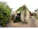 The exterior showcases desert landscaping, mature greenery, and a textured stucco wall for a serene desert lifestyle at 5120 E Janice Way, Scottsdale, AZ 85254