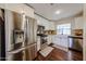 Bright kitchen features stainless steel appliances, white cabinetry, and a farmhouse sink at 5120 E Janice Way, Scottsdale, AZ 85254