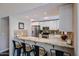 Updated kitchen with granite counters, breakfast bar, stainless appliances and white cabinets at 5120 E Janice Way, Scottsdale, AZ 85254