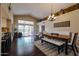 Bright living room featuring a dining area, dark wood floors and a large glass sliding door to the outside at 5120 E Janice Way, Scottsdale, AZ 85254