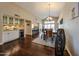 Open concept living room features wood floors, wet bar and bright dining space at 5120 E Janice Way, Scottsdale, AZ 85254