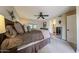 Neutral main bedroom features plush bed, ensuite bathroom, and dark toned ceiling fan at 5120 E Janice Way, Scottsdale, AZ 85254