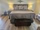 Main bedroom features wood-look flooring, a king bed, decorative lamps, and accent decor at 5120 E Janice Way, Scottsdale, AZ 85254