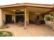 The covered patio has ceiling fans, comfortable seating, and terracotta tile floors, ideal for outdoor entertaining at 5120 E Janice Way, Scottsdale, AZ 85254