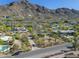 Scenic view of the property nestled in the desert landscape with mountain backdrop at 5412 E Rockridge Rd, Phoenix, AZ 85018