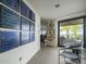 Bright entryway featuring modern art and glass doors leading to an outdoor seating area at 5412 E Rockridge Rd, Phoenix, AZ 85018