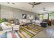 Spacious living room with exposed brick walls, colorful rug, and comfortable seating arrangements at 5412 E Rockridge Rd, Phoenix, AZ 85018