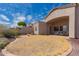 Wide angle of the backyard showcasing desert landscaping and the rear of the home at 6043 W Robin Ln, Glendale, AZ 85310