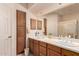 Bathroom features double sinks, wood cabinets, and ample storage at 6043 W Robin Ln, Glendale, AZ 85310