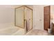 Bathroom features glass shower, tub, and wood cabinets at 6043 W Robin Ln, Glendale, AZ 85310