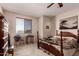 Bedroom includes ceiling fan, window, and traditional furnishings at 6043 W Robin Ln, Glendale, AZ 85310