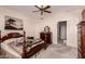 Bedroom includes ceiling fan, window, and traditional furnishings at 6043 W Robin Ln, Glendale, AZ 85310