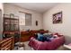 Bedroom with window, vintage bird cage, and poster hanging above the bed at 6043 W Robin Ln, Glendale, AZ 85310