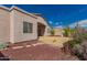 Exterior view of the home showing the desert landscaping in the backyard at 6043 W Robin Ln, Glendale, AZ 85310
