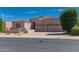 Attractive single-story home with a well-maintained front yard and three car garage, offering curb appeal and convenience at 6043 W Robin Ln, Glendale, AZ 85310