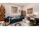 This small home office features a green leather couch and large wooden bookcase at 6043 W Robin Ln, Glendale, AZ 85310