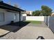 A private backyard featuring an easy-care synthetic lawn and a shady covered patio at 6217 W Comet Ave, Glendale, AZ 85302