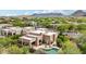 Aerial view of the home with a pool, desert landscaping, and mountain views at 11366 E White Feather Ln, Scottsdale, AZ 85262