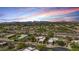 Desert homes bask under a vibrant sunset, nestled near scenic mountain vistas at 11366 E White Feather Ln, Scottsdale, AZ 85262