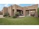 Beautiful outdoor space with synthetic grass, covered patio, and desert landscaping for outdoor living at 11366 E White Feather Ln, Scottsdale, AZ 85262