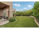 Backyard with turf grass and a covered patio at 11366 E White Feather Ln, Scottsdale, AZ 85262