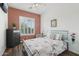 Cozy bedroom with warm accents features a plush bed, a window with shutter, and wood-look flooring at 11366 E White Feather Ln, Scottsdale, AZ 85262