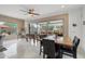Bright dining area features a wooden table, game machines and sliding doors to the outdoor living space at 11366 E White Feather Ln, Scottsdale, AZ 85262