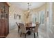 Elegant dining room with a stylish chandelier and large window with shutter offer ample natural light at 11366 E White Feather Ln, Scottsdale, AZ 85262