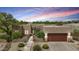 A lovely single-story home featuring a stucco exterior, desert landscaping, and a cozy two-car garage at dusk at 11366 E White Feather Ln, Scottsdale, AZ 85262