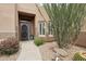 Close-up of a charming home's front entrance with desert landscaping and large decorative succulents at 11366 E White Feather Ln, Scottsdale, AZ 85262
