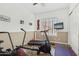 Home gym includes exercise equipment, wood-look floors, and natural light at 11366 E White Feather Ln, Scottsdale, AZ 85262