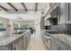 Kitchen featuring a large island with seating, designer backsplash, and open access to the dining and living areas at 11366 E White Feather Ln, Scottsdale, AZ 85262