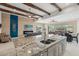 Open-concept kitchen and living space, featuring wood beam ceilings and stainless-steel appliances at 11366 E White Feather Ln, Scottsdale, AZ 85262