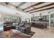Spacious open-concept living area with exposed wood beams, a large kitchen, and comfortable seating area at 11366 E White Feather Ln, Scottsdale, AZ 85262