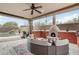 Outdoor living space features a fireplace, seating, bar, and view of the waterfall pool at 11366 E White Feather Ln, Scottsdale, AZ 85262