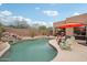 Backyard with waterfall pool, patio, and seating at 11366 E White Feather Ln, Scottsdale, AZ 85262