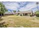 Expansive backyard with lush grass, mature trees, covered patio, offering plenty of space for recreation and relaxation at 14221 N 45Th St, Phoenix, AZ 85032