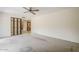 Carpeted bedroom with open doorway access to kitchen; ceiling fan installed at 14221 N 45Th St, Phoenix, AZ 85032