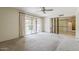 Carpeted bedroom with sliding glass door access to the backyard and mirrored closet at 14221 N 45Th St, Phoenix, AZ 85032