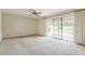 Spacious carpeted bedroom with ceiling fan and sliding glass doors to the backyard at 14221 N 45Th St, Phoenix, AZ 85032