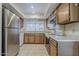 Well-lit kitchen features stainless steel refrigerator and standard appliances at 14221 N 45Th St, Phoenix, AZ 85032