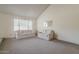 Spacious living room featuring neutral carpet, white walls, and a large window at 14221 N 45Th St, Phoenix, AZ 85032