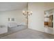 Bright living area with a modern chandelier and a view into the kitchen at 14221 N 45Th St, Phoenix, AZ 85032