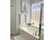 Bathroom with a soaking tub and shower featuring a unique glass block window for privacy and light at 14253 N Honeysuckle N Dr, Fountain Hills, AZ 85268